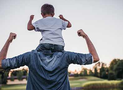 son on his fathers shoulders 